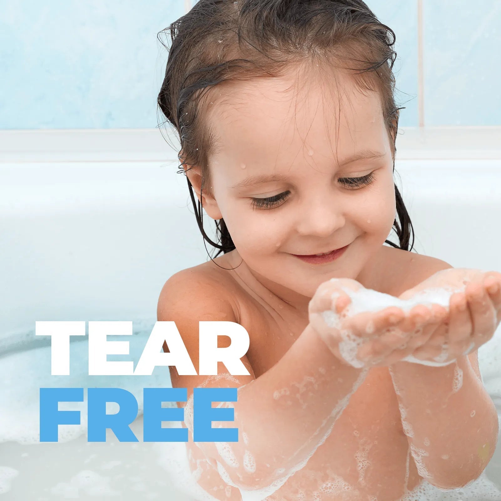 Happy toddler playing with bubbly lather in a bathtub, featuring the text Tear Free for Baby Jolie hair and body wash.