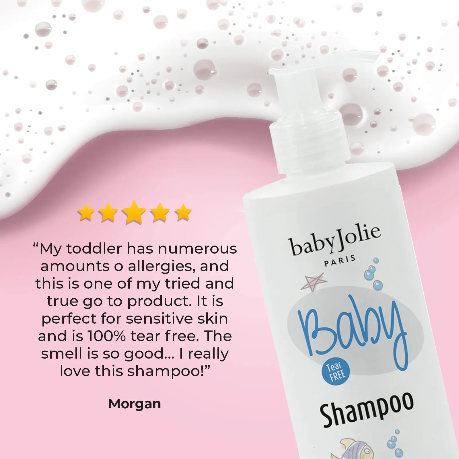 Baby Jolie tear-free baby shampoo bottle with a pump dispenser on a pink background with soapy bubbles and a five-star review.