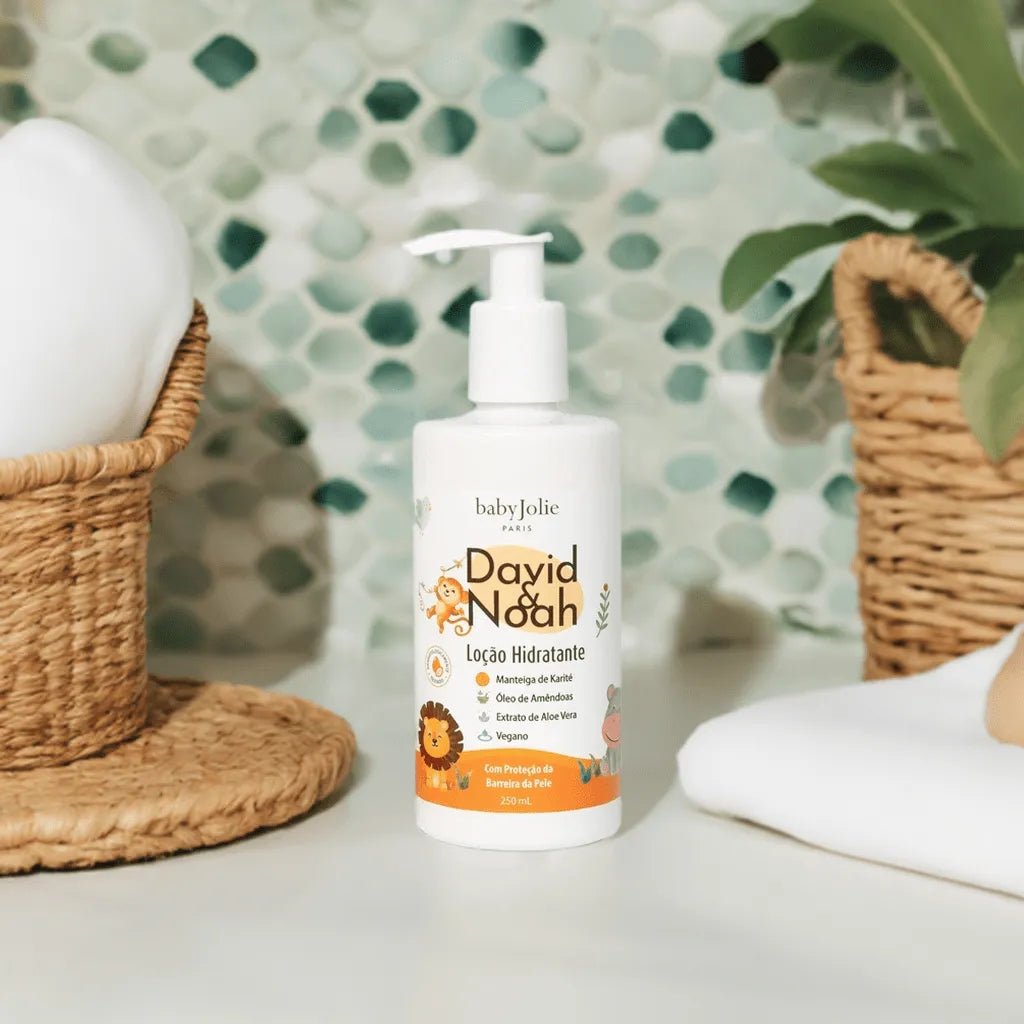 White 250ml David & Noah moisturizing lotion bottle with a pump dispenser, featuring cute lion illustrations and orange accents.