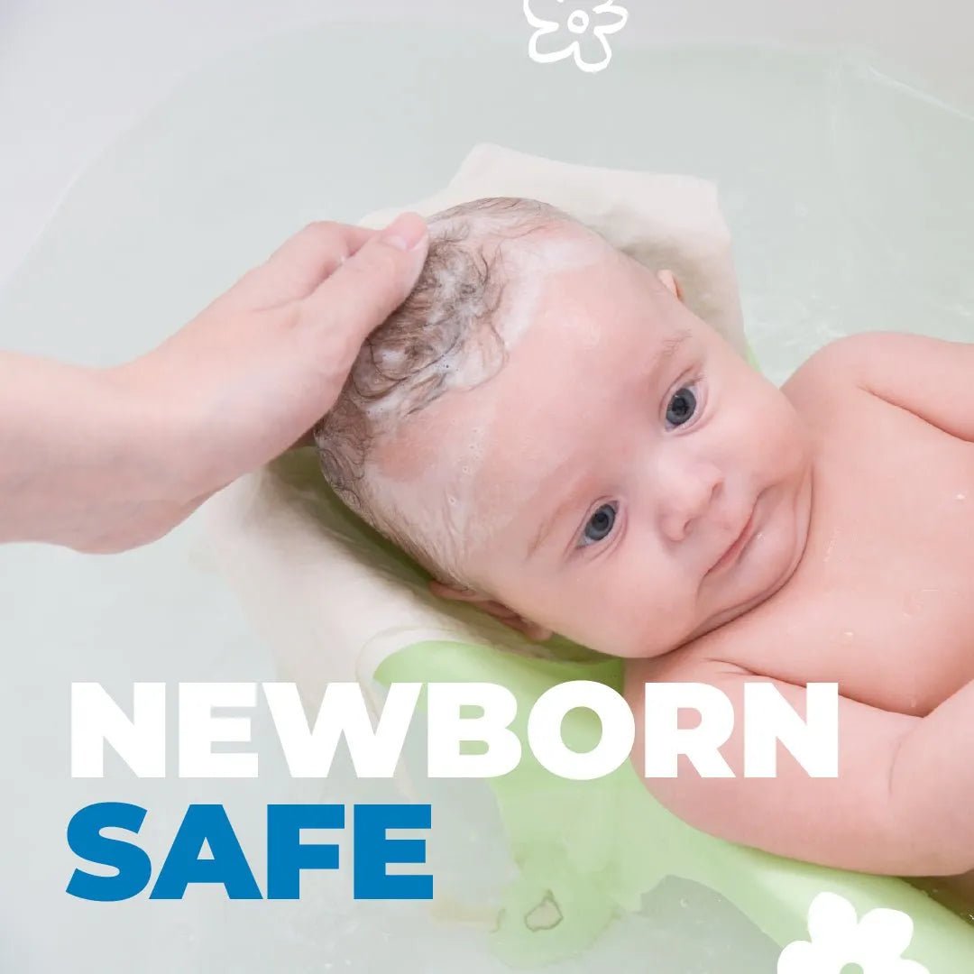 A parent gently washing a newborn's hair with Baby Jolie foam shampoo in a light green baby bath seat.