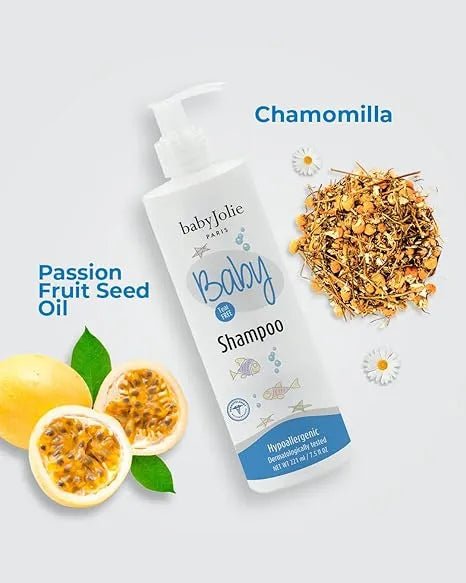 Baby Jolie tear-free shampoo bottle with pump, surrounded by fresh passion fruit and dried chamomile flowers.