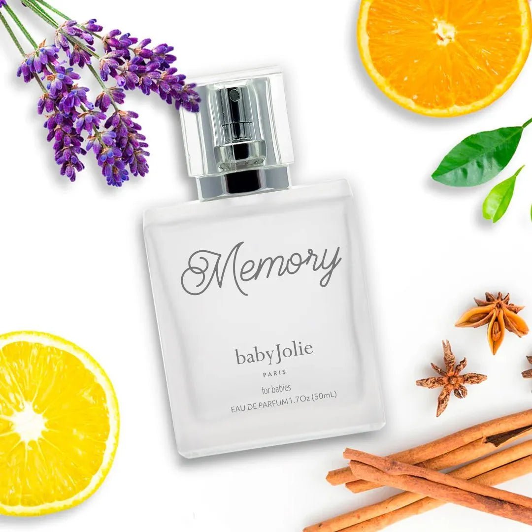 Baby Jolie Memory perfume bottle surrounded by lavender, orange slices, star anise, and cinnamon sticks.